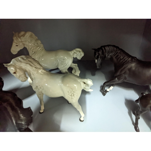 349 - A collection of Beswick and Royal Doulton horses and foals, along with a Franklin Mint model of Blac... 