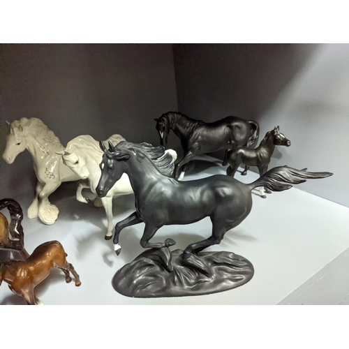 349 - A collection of Beswick and Royal Doulton horses and foals, along with a Franklin Mint model of Blac... 