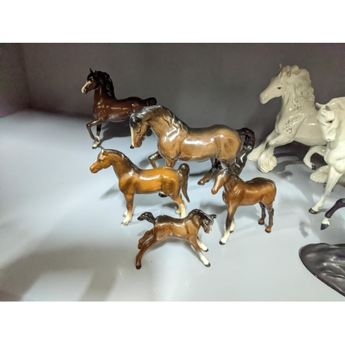 349 - A collection of Beswick and Royal Doulton horses and foals, along with a Franklin Mint model of Blac... 