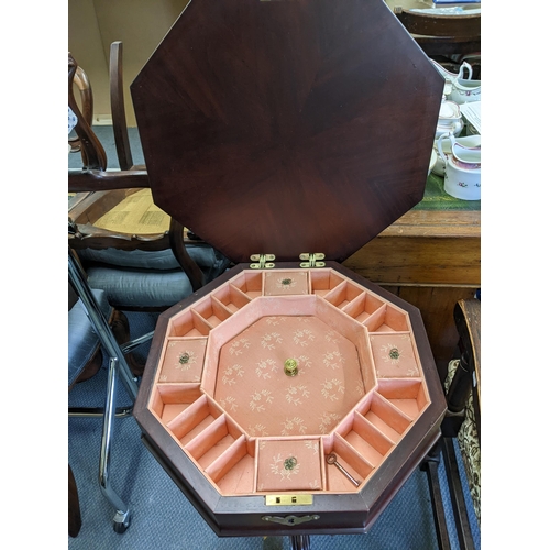 369 - A 20th century reproduction Regency style sewing pedestal table with octagonal hinged lid revealing ... 