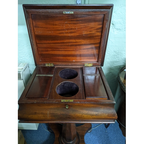 371 - A Regency mahogany pedestal teapoy on quatrefoil base with turned feet, hinged top revealing a fitte... 