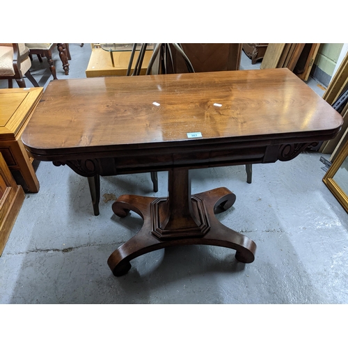 361 - A Regency rosewood pedestal fold over card table with inset green baize, shaped corners on square ta... 