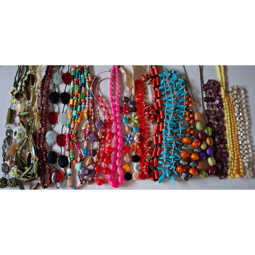 76 - A quantity of mainly late 20th Century bead necklaces, brooches and bracelets to include wooden, gla... 