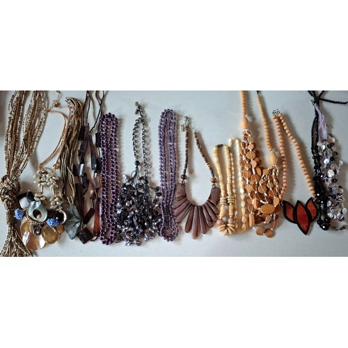 76 - A quantity of mainly late 20th Century bead necklaces, brooches and bracelets to include wooden, gla... 