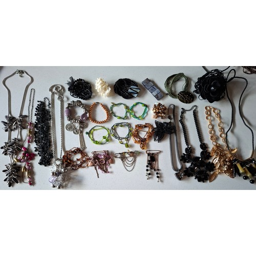 76 - A quantity of mainly late 20th Century bead necklaces, brooches and bracelets to include wooden, gla... 