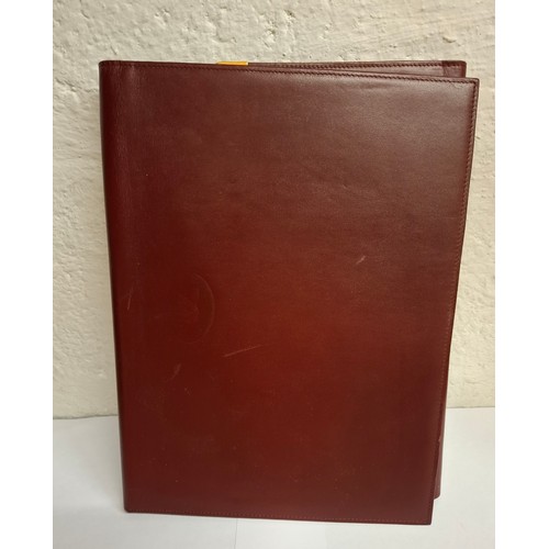 23 - Cartier - A burgundy leather stationary folio with Playboy pressed insignia to the front and Playboy... 