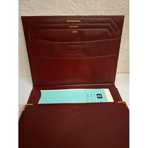 23 - Cartier - A burgundy leather stationary folio with Playboy pressed insignia to the front and Playboy... 