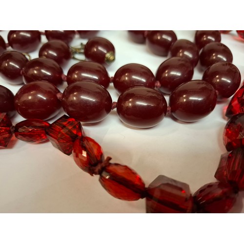 41 - A vintage cherry amber resin suite comprising a necklace of 31 large oval beads, approx 87cm total l... 