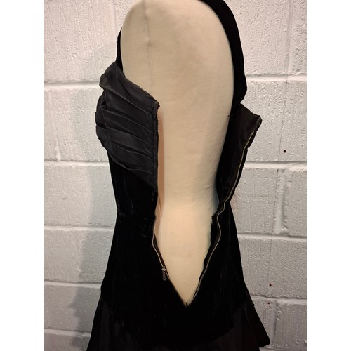 93 - A vintage black velvet and taffeta evening gown with tiered skirt together with a detachable multi l... 