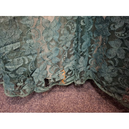 92 - A mid 20th Century Lee Delman for Bourne & Holligsworth fern green evening gown having a lace outer ... 