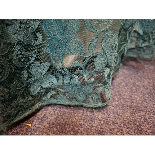 92 - A mid 20th Century Lee Delman for Bourne & Holligsworth fern green evening gown having a lace outer ... 