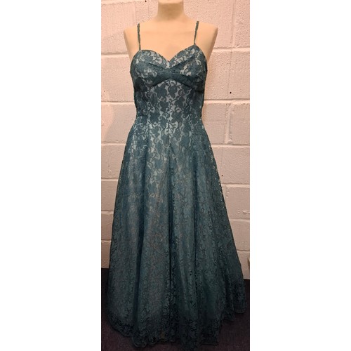 A mid 20th Century Lee Delman for Bourne & Holligsworth fern green evening gown having a lace outer layer and long sash tie to the rear, approx 34" chest x 58" long. Location:Rail
Condition:Straps A/F and several nholes to the lace at the hemline-see additional photos