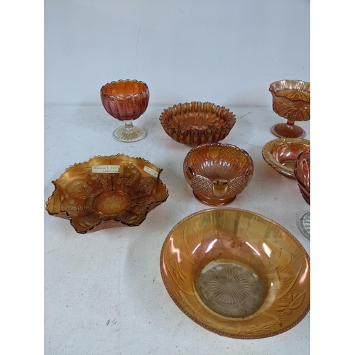 131 - A collection of Marigold carnival glass to include dishes, plates and stemmed bowls Location: 3.3
If... 