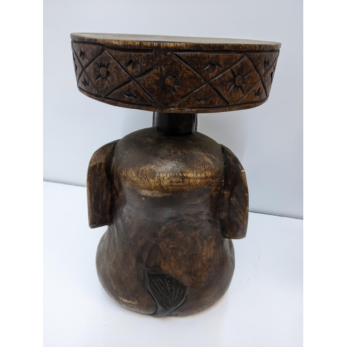 133 - Treen carved items to include a South Asian carved head of Lady Buddha, along with a stool fashioned... 