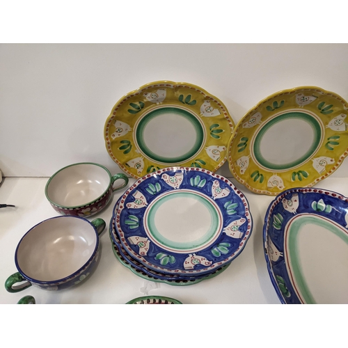 139 - An Italian hand painted dinner service to include plates, a platter, a serving dish and other items
... 