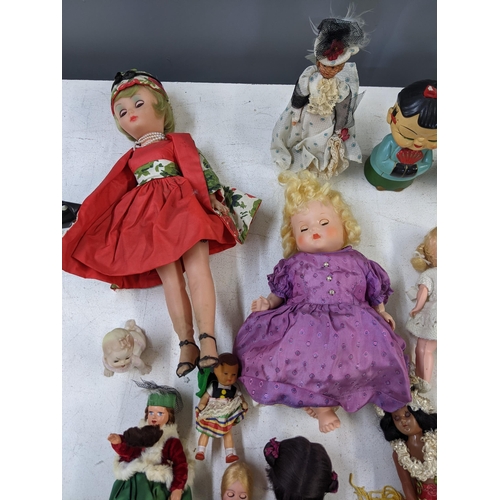 14 - Mixed dolls to include nodding dolls, some in formal dress and dolls fashioned as young children A/F... 