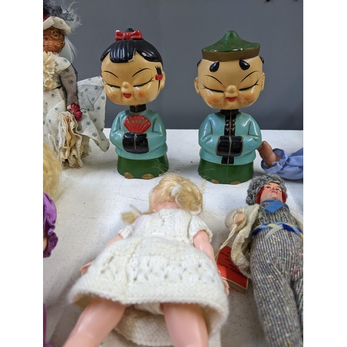 14 - Mixed dolls to include nodding dolls, some in formal dress and dolls fashioned as young children A/F... 