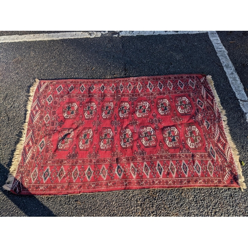 144 - Two rugs to include a Tekki Bokhara rug measuring 107cm x 69cm, together with later reproduction Bok... 