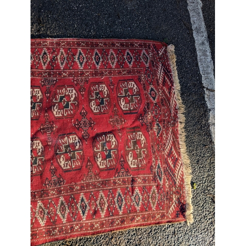 144 - Two rugs to include a Tekki Bokhara rug measuring 107cm x 69cm, together with later reproduction Bok... 