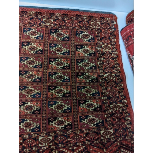 144 - Two rugs to include a Tekki Bokhara rug measuring 107cm x 69cm, together with later reproduction Bok... 