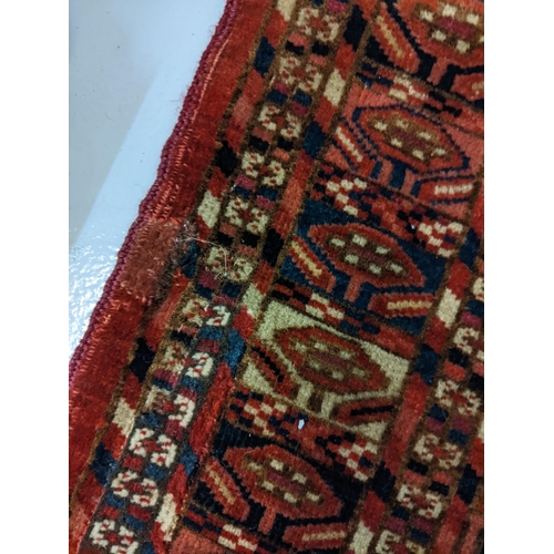 144 - Two rugs to include a Tekki Bokhara rug measuring 107cm x 69cm, together with later reproduction Bok... 