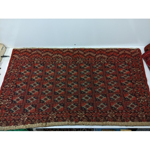 144 - Two rugs to include a Tekki Bokhara rug measuring 107cm x 69cm, together with later reproduction Bok... 