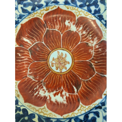 149 - An 18th century Chinese plate with a red rose central motif with some historic evidence of repair
Lo... 