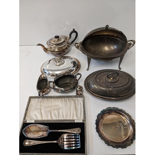 155 - A collection of silver plated items to include a breakfast dish with a hinged lid and four legs, a t... 