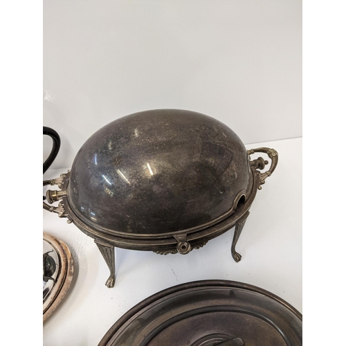 155 - A collection of silver plated items to include a breakfast dish with a hinged lid and four legs, a t... 