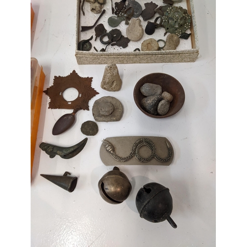 176 - A collection of metal detector finds to include bells, a boot strap, a thimble, a brooch and other i... 