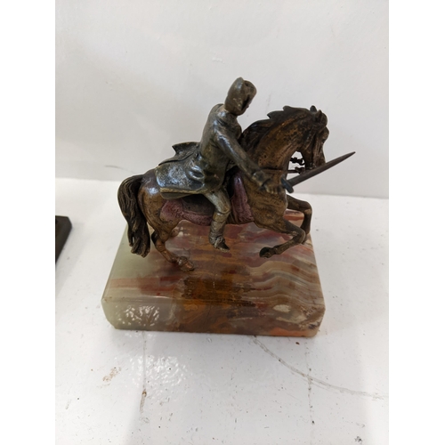 188 - A casting figure of Napoleon on horseback along with a pressed metal casting of Napoleon on a steppe... 