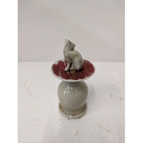 189 - A ceramic lipped cent bottle fashioned as a cat on a plinth
Location: 4.1
If there is no condition r... 