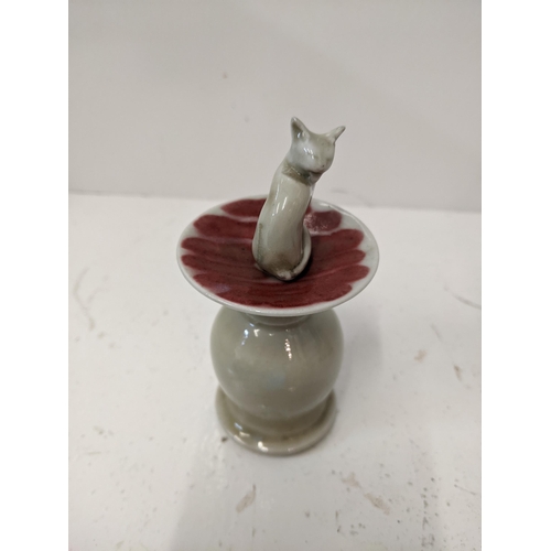 189 - A ceramic lipped cent bottle fashioned as a cat on a plinth
Location: 4.1
If there is no condition r... 