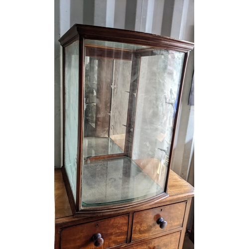 203 - An early 20th century cabinet having a bow front, moulded cornice and door to the reverse, 80.5cm h ... 