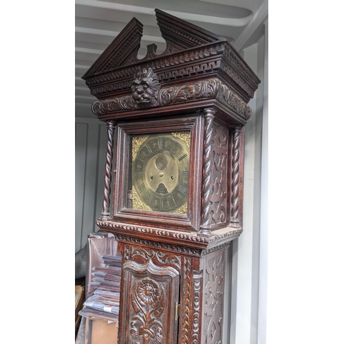 213 - An 18th century heavily carved oak 8-day longcase clock, the gilt dial signed Thomas Verner, 220cm h... 