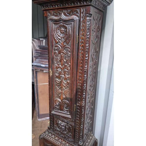 213 - An 18th century heavily carved oak 8-day longcase clock, the gilt dial signed Thomas Verner, 220cm h... 