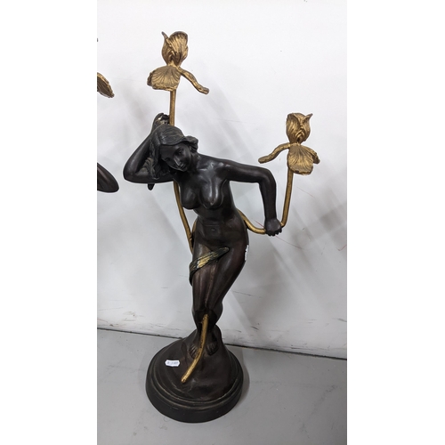 224 - A pair of Art Nouveau style bronzed figural candlesticks in the form of a nude ladies among gilt pai... 