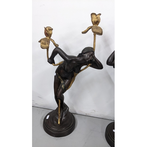 224 - A pair of Art Nouveau style bronzed figural candlesticks in the form of a nude ladies among gilt pai... 