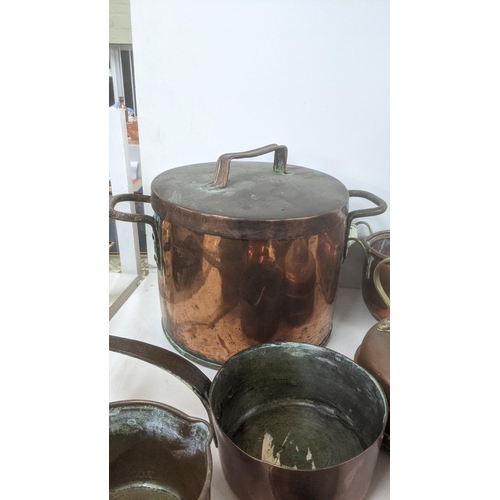 37 - A mixed lot of copperware to include a large twin handled cooking pot, a twin handled planter, a mea... 