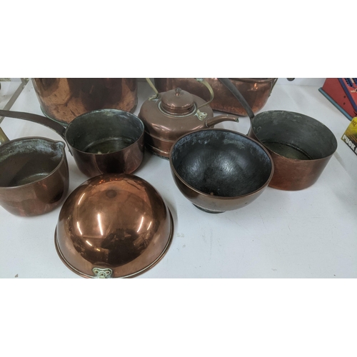 37 - A mixed lot of copperware to include a large twin handled cooking pot, a twin handled planter, a mea... 