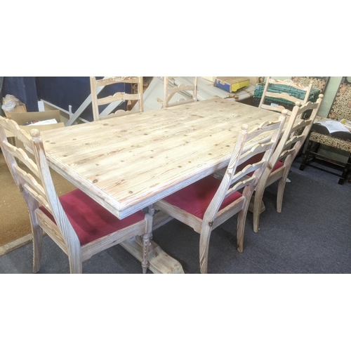 50 - A modern pine dining table on turned legs, united by stretcher, six matching chairs with red upholst... 