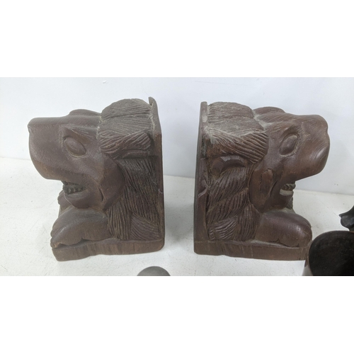 54 - Wooden items and collectables to include a pair of lion head bookends, figures, Russian buildings, a... 