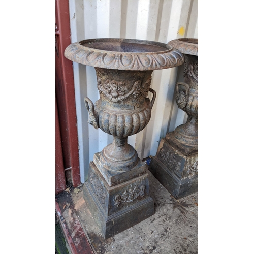 66 - A pair of 20th century cast iron Grecian style campana shaped planters, having egg and dart rims, li... 