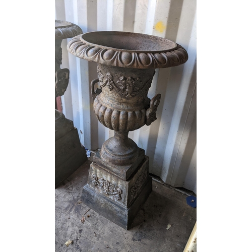 66 - A pair of 20th century cast iron Grecian style campana shaped planters, having egg and dart rims, li... 