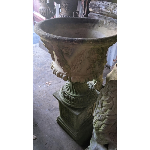 68 - A garden stoneware urn shaped planter, moulded with flowers and with a wrythen base, 99.5cm h x 52cm... 