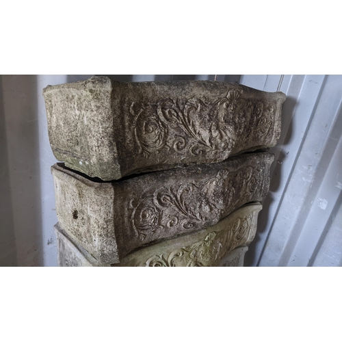 69 - A pair of garden stoneware trough planters, cast with cherubs among vining scrolls, 20cm h x 74cm w
... 