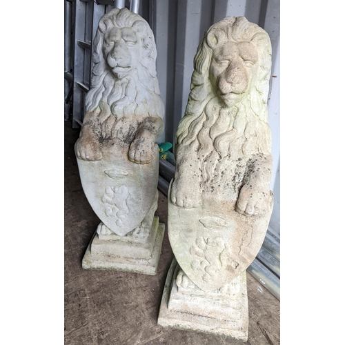 76 - A pair of garden stoneware sculptures of lions bearing armorial shields, 80cm h x 23cm w
Location: R... 