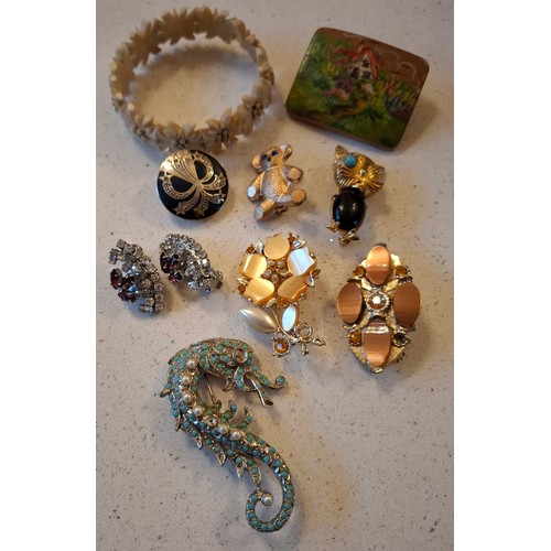 102 - A quantity of vintage costume jewellery and buckles to include a bone edelweiss bracelet with floral... 