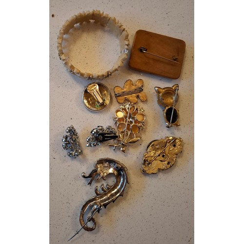 102 - A quantity of vintage costume jewellery and buckles to include a bone edelweiss bracelet with floral... 