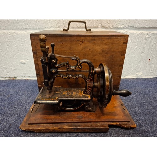 36 - A 19th Century, possibly Charles Raymond chainstitch sewing machine A/F, painted black and decorated... 